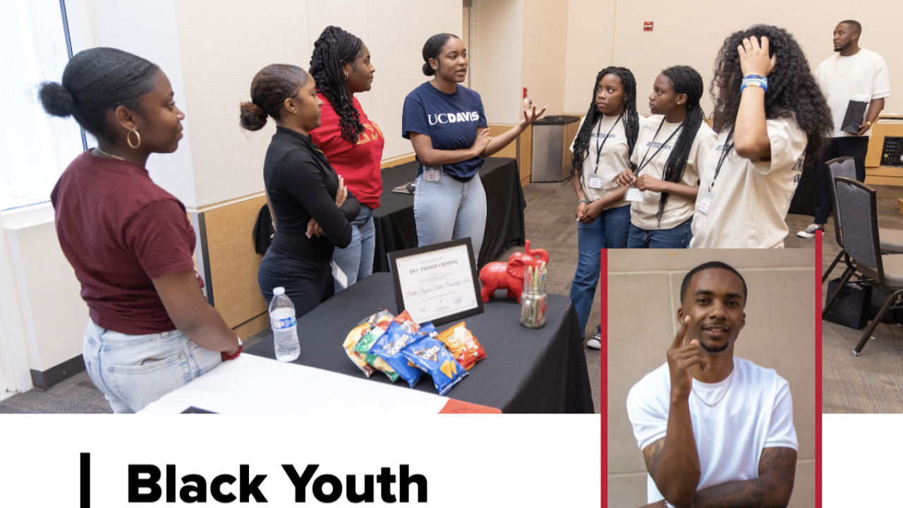 Group of young people engaged in discussion at a symposium, with snacks on a table nearby.