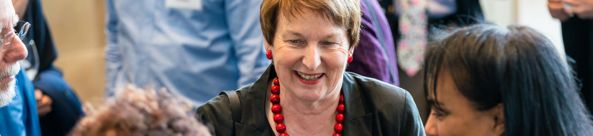 Joanna Regulska in conversation with attendees at a reception